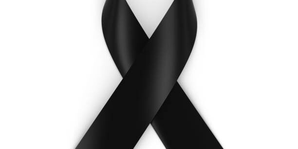 Black Mourning Ribbon isolated on white with shadows